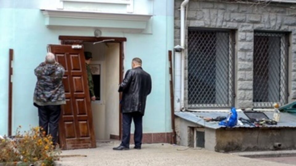 Группа неизвестных, когда их не впустили в здание, выломала входную дверь