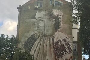 Автор граффити --- австралийский художник Гвидо Ван Хелтен