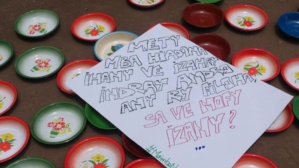 На пустых тарелках активисты разложили плакаты с требованиями не злоупотреблять народными деньгами