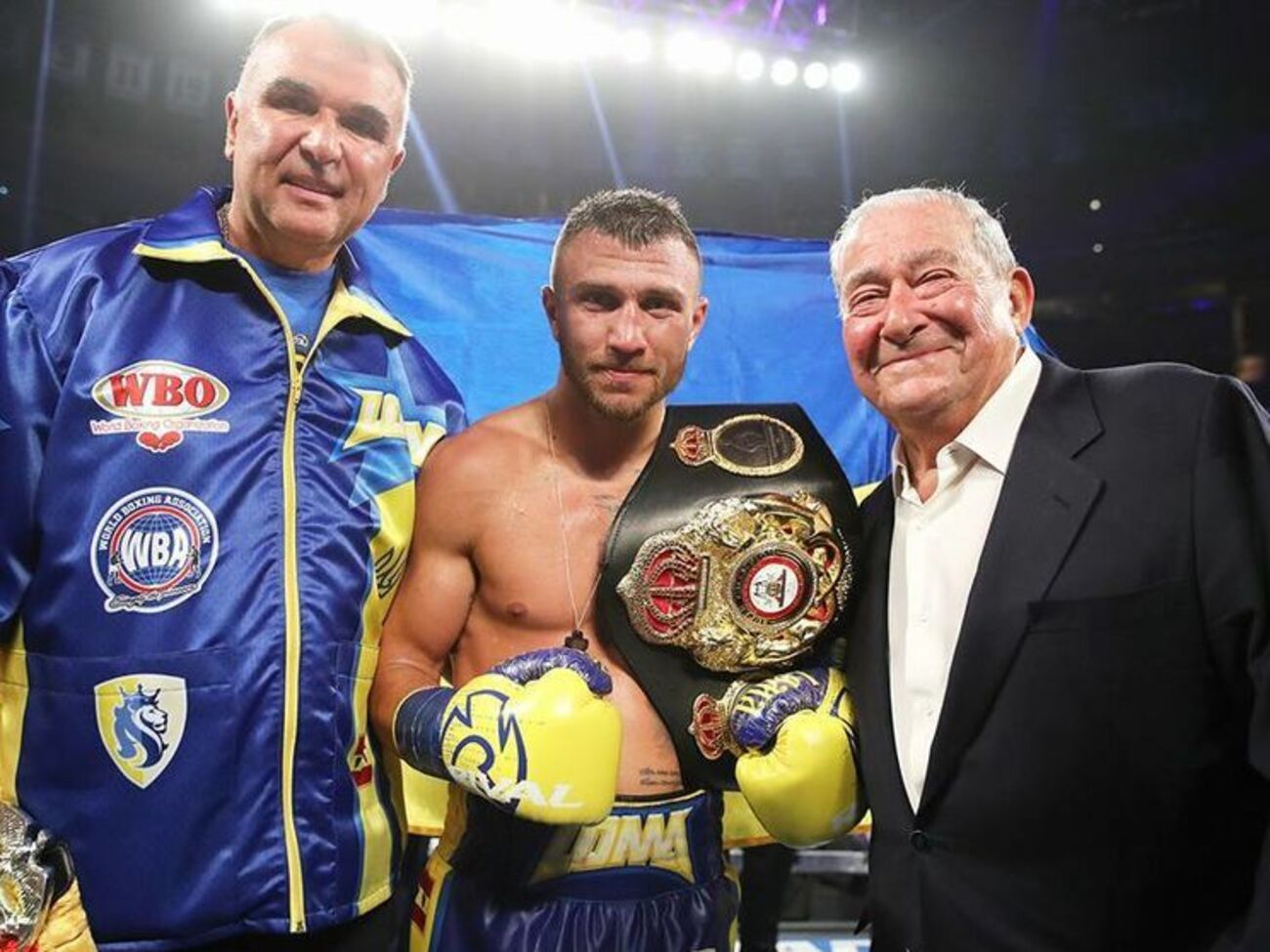 Василь Ломаченко (у центрі) завоював титул чемпіона світу за версією WBA у легкій вазі