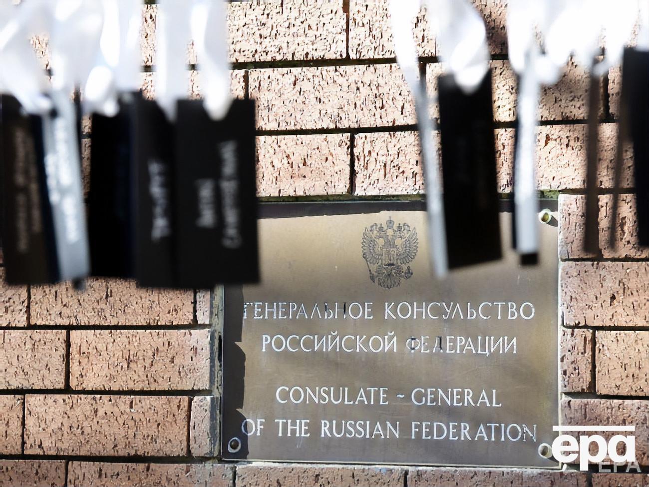 Собравшиеся повесили таблички с именами жертв у входа в дипмиссию