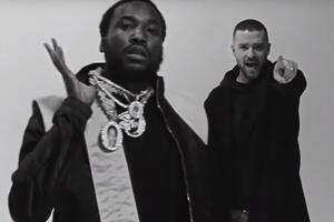 Meek Mill (на скриншоте слева) в кадре появляется с кулоном, в центре которого расположен портрет рэпера Nipsey Hussle