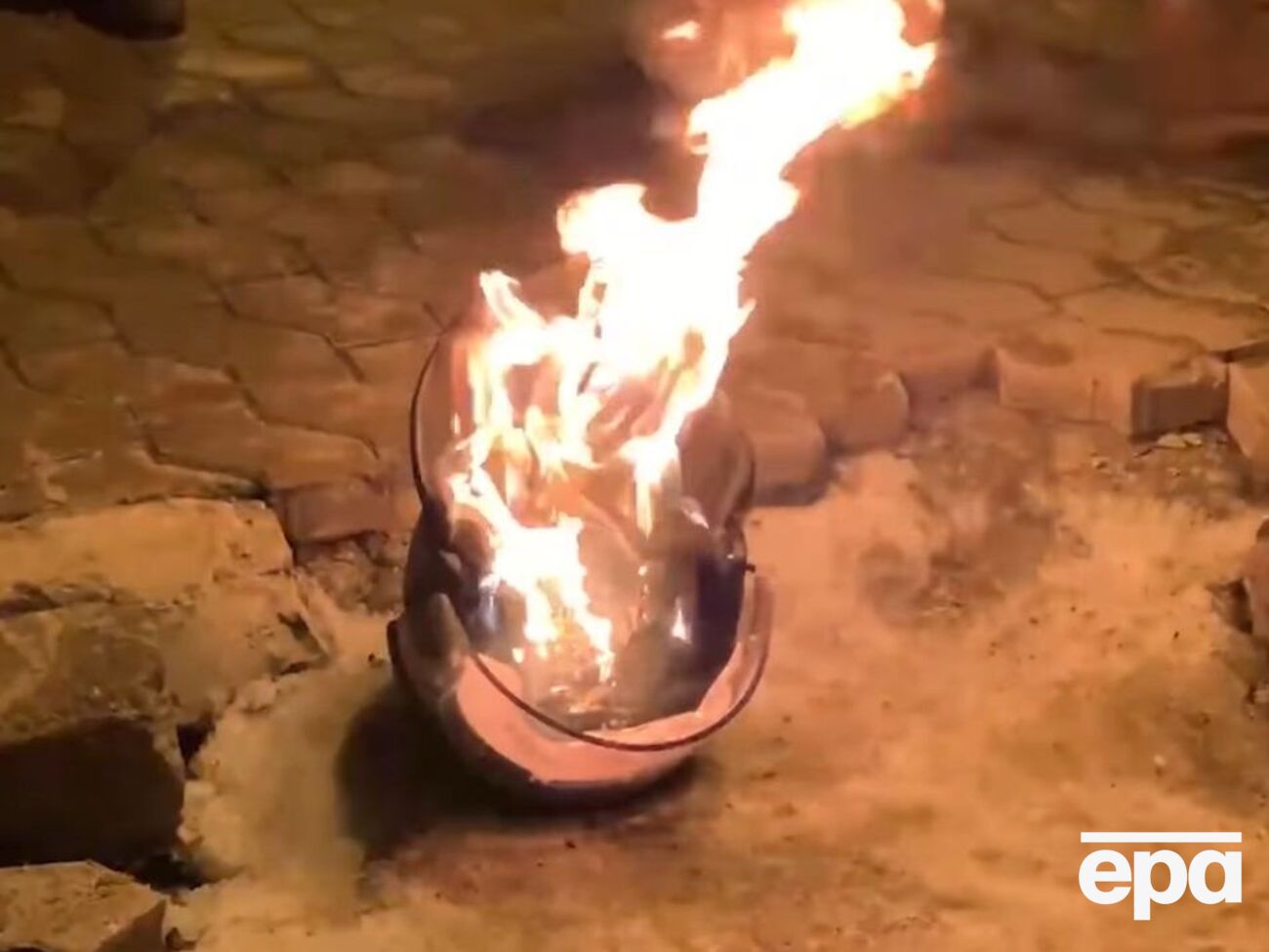 Горящий шлем полицейского на акции под Офисом президента