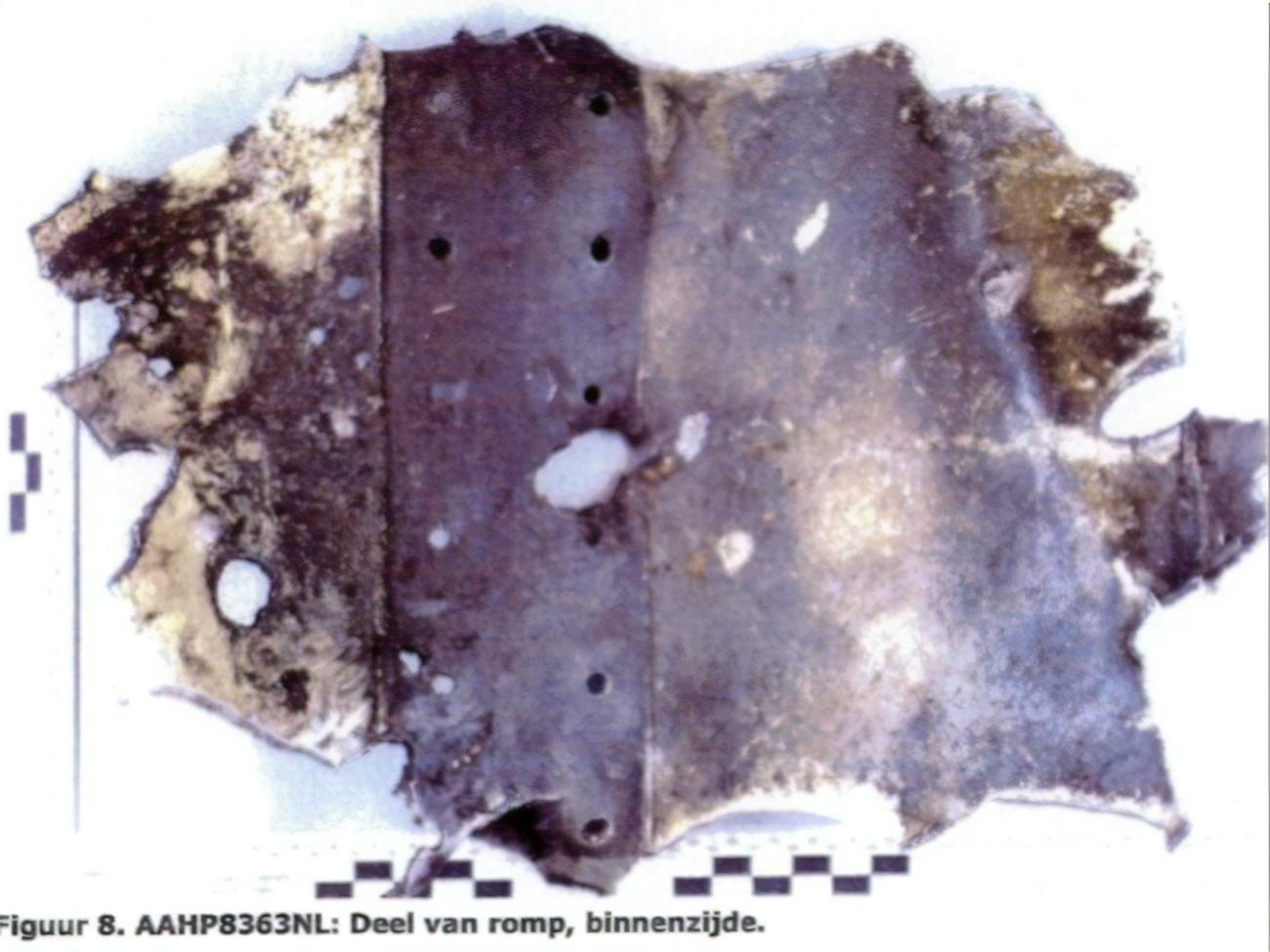 Фрагмент фюзеляжа с пробоинами. В них нашли следы металлов, чужеродных для самолета