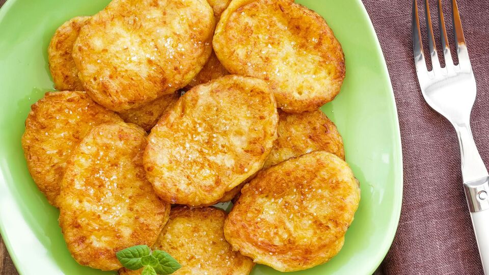 Готовые деруны выложите на противень, застеленный пергаментом, и поставьте в разогретую духовку на 10 минут