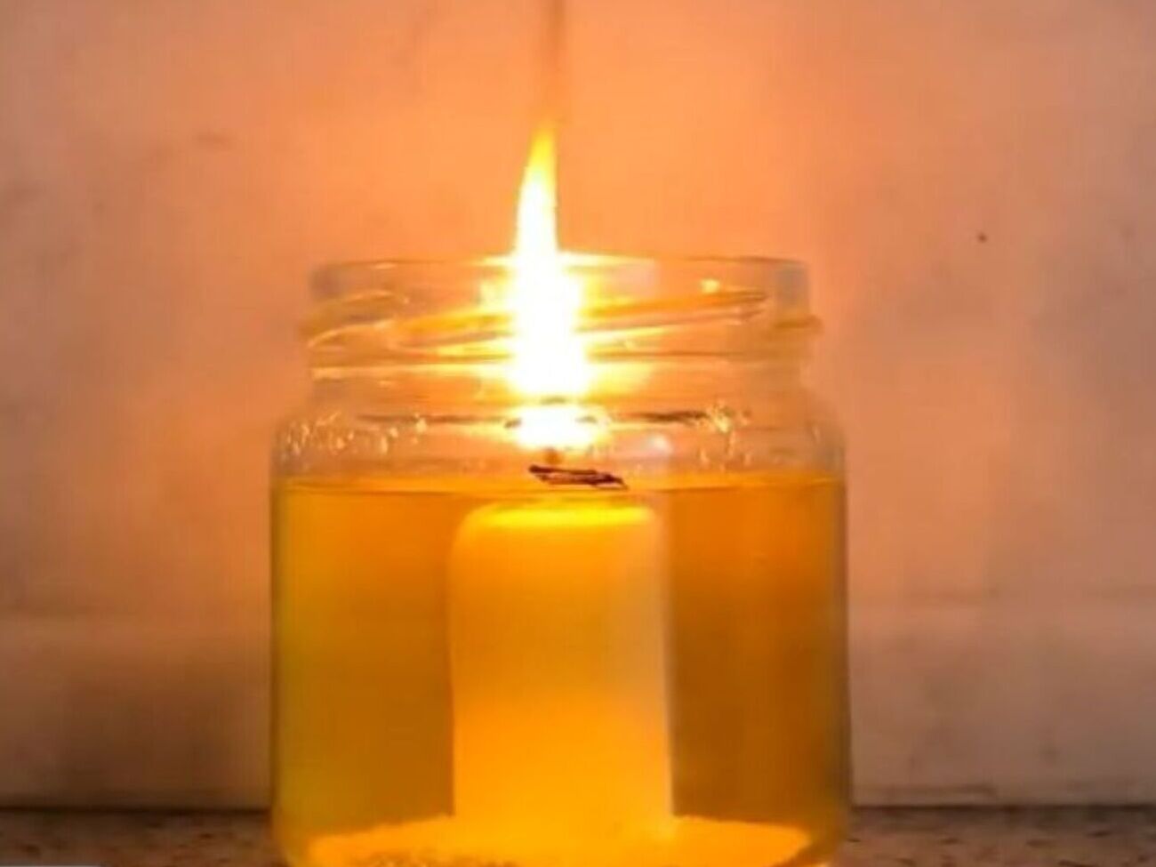 Для такой "вечной" свечи возьмите растительное масло, стеклянную банку и свечу