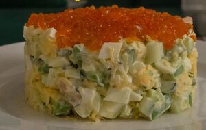 Гарно оформте салат на тарілці, а зверху додайте кілька креветок і ложечку червоної ікри