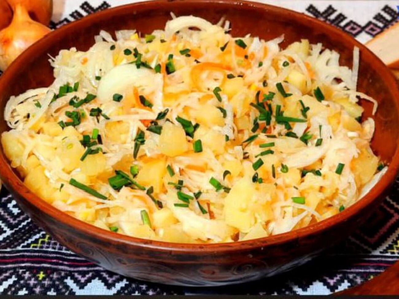 Змішайте в посудині квашену капусту, картоплю, цибулю, часник