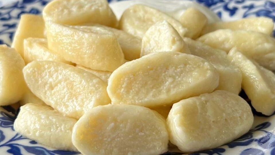 Викладіть готові вареники на тарілку й додайте шматочок вершкового масла